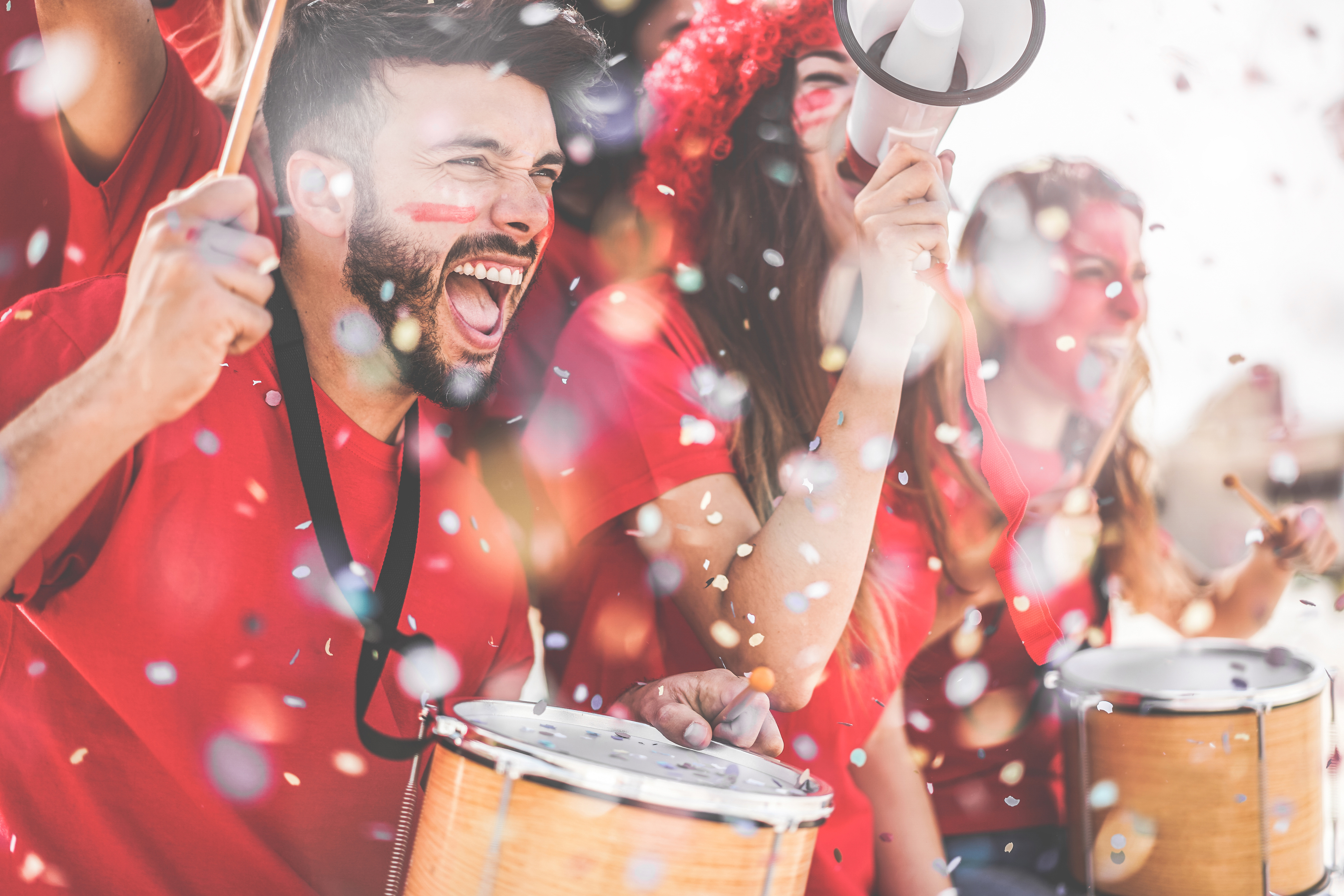 Football fans cheering with confetti falling during a stadium celebration